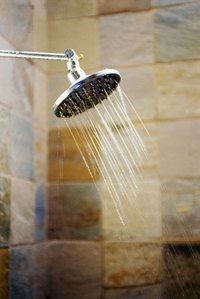 An elevated shower base accomodates a plumbing trap.