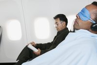 Two men are flying on a commercial plane.