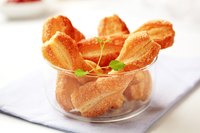 Serve the warmed cheese straws in individual cups as an appetizer.