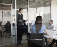 Employee entering business meeting late