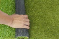 Artificial turf rolled out by hand