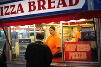 Woman in food concession trailer selling treats.
