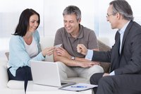 An image of an accountant and individual holding a check.