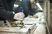 Technicians working on an assembly line in a factory.
