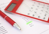 Close-up of calculator over printed company data