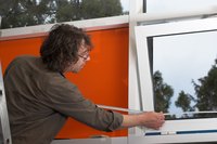 Man taking the dimensions of a window with measuring tape