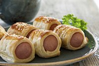 Dress up basic pigs in a blanket by using savory additions.