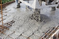 Concrete workers pouring concrete.