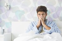 Sick man sitting in bed