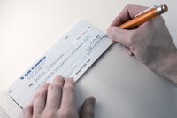 Close-up of man signing check