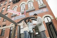 A buyer's specialist meeting with a couple outside of an open house.