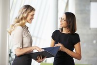Employee going over paperwork with boss