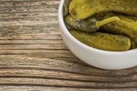 Bowl of pickles on wooden table
