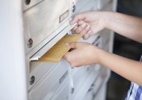 Mail being delivered to a mailbox.