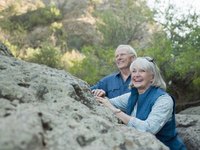 Smiling retired couple out on a hike.