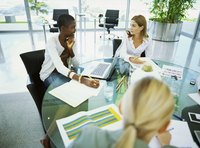 Three business women are working together.