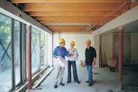 Couple listening to contractor in a residential construction site.