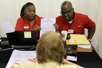 A client talking with Wells Fargo mortgage lenders at a desk.