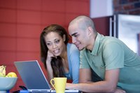 Woman reading boyfriend's biography on laptop.