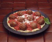 Drain the grease from meatballs before adding them to a dish.