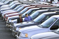 Couple looking at vehicles on a car lot.