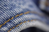 Refashion an old pair of denim jeans with bleach.