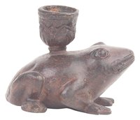 A wooden frog percussion instrument resembles a sitting frog.