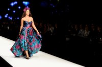 A maxi dress in a tropical or floral print is a flattering resort wear option for a plus-sized woman.