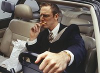 A businessman eating food on the go in his car.