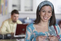 A portrait of a young woman holding a credit card.