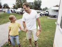 Father and daughter walking through an RV campgrounds.