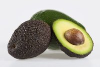 Fruits ripen best in room temperature however, ripening an avocado that's already been cut open is best done in the refrigerator.