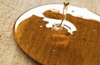 Close-up of maple syrup being poured on wood