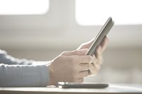 A close-up of a professional using a digital tablet.