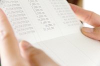 A close-up of a person reading a bank statement.