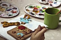 Use flower impressions on clay to create a decorative tile.