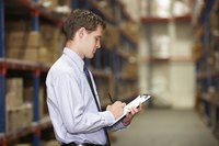 Man checking warehouse inventory
