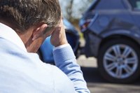 A close-up of a man at the scene of a fender bender.
