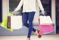 A young woman holding several shopping bags