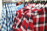 Flannel shirts hanging in clothing store.