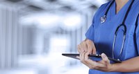 Close-up of hospital employee using tablet