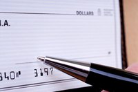 Pen signing a cheque.