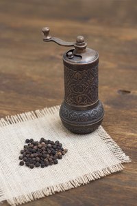 Make a paper funnel to slide peppercorns into a mill.