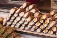 A platter of cannoli in an Italian bakery.