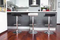 White baseboard trim contrasts with floors and cabinets.