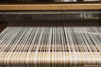 A loom with yarn on it.