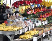 Fruit, vegetables and flowers in a stall at a farmer's market.
