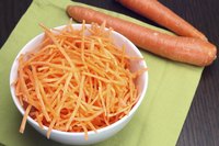 Smal bowl of shredded carrots.