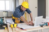 A contractor looks over building plans.