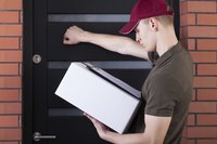 Delivery man knocking on door with parcel in hands